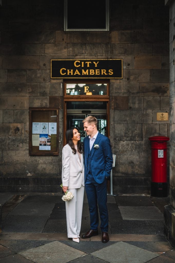 Couple smiling outside edinburgh City chambers