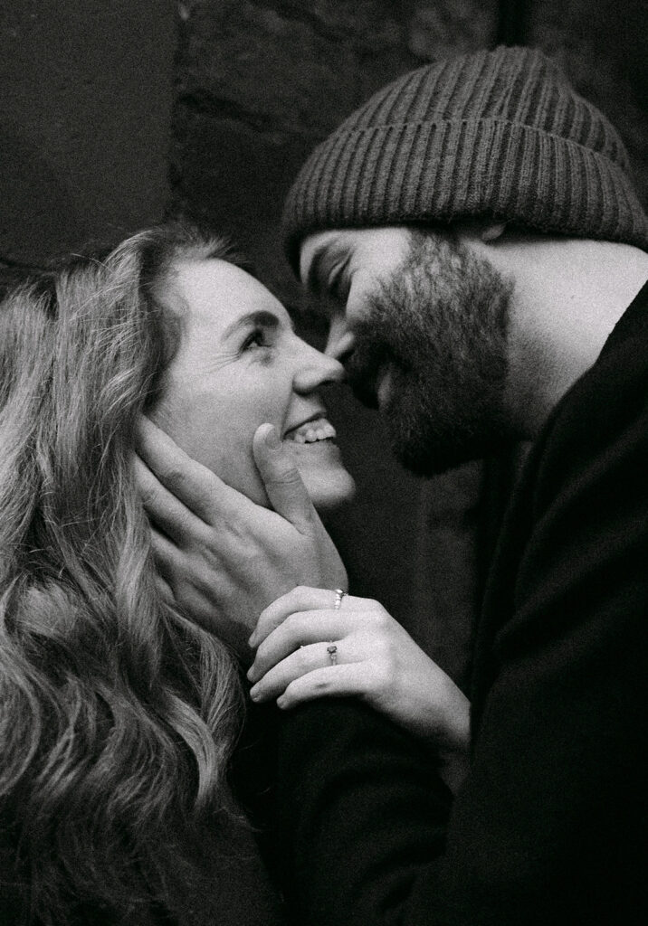close up shot of couple leaning in for a kiss and smiling