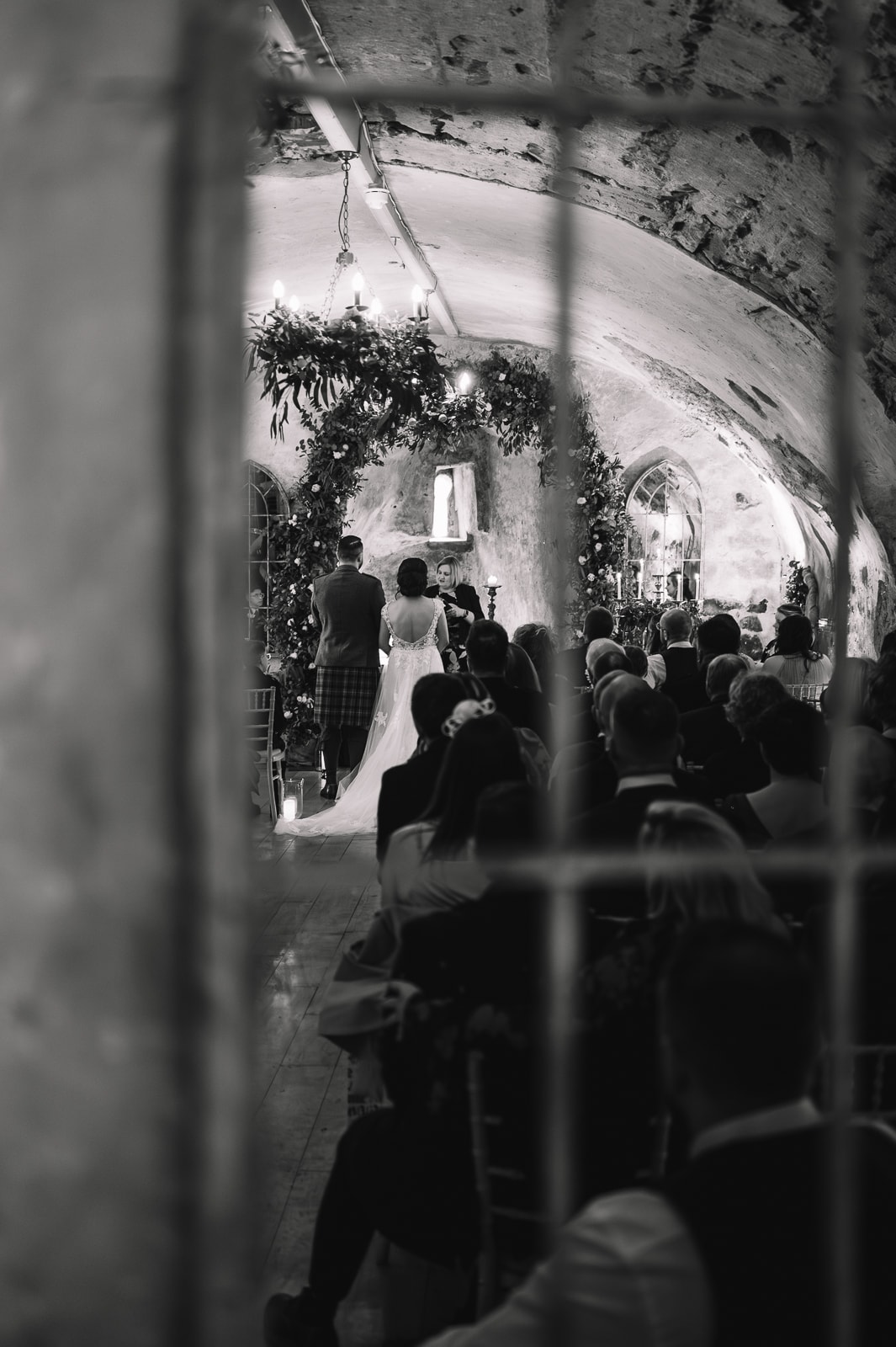 Black and white ceremony moment in vaulted room