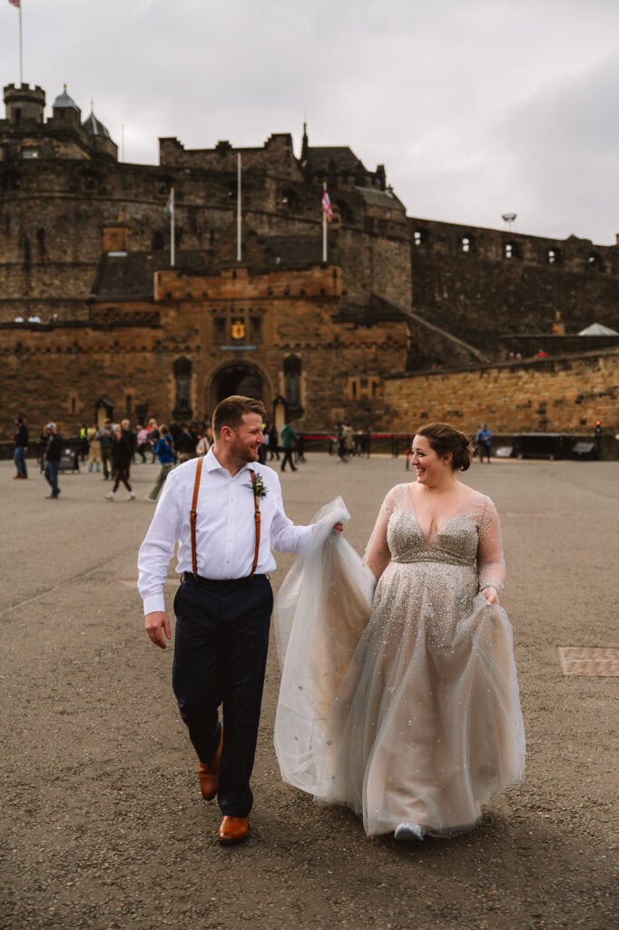 Couple walking together in front of Edinburgh Castle