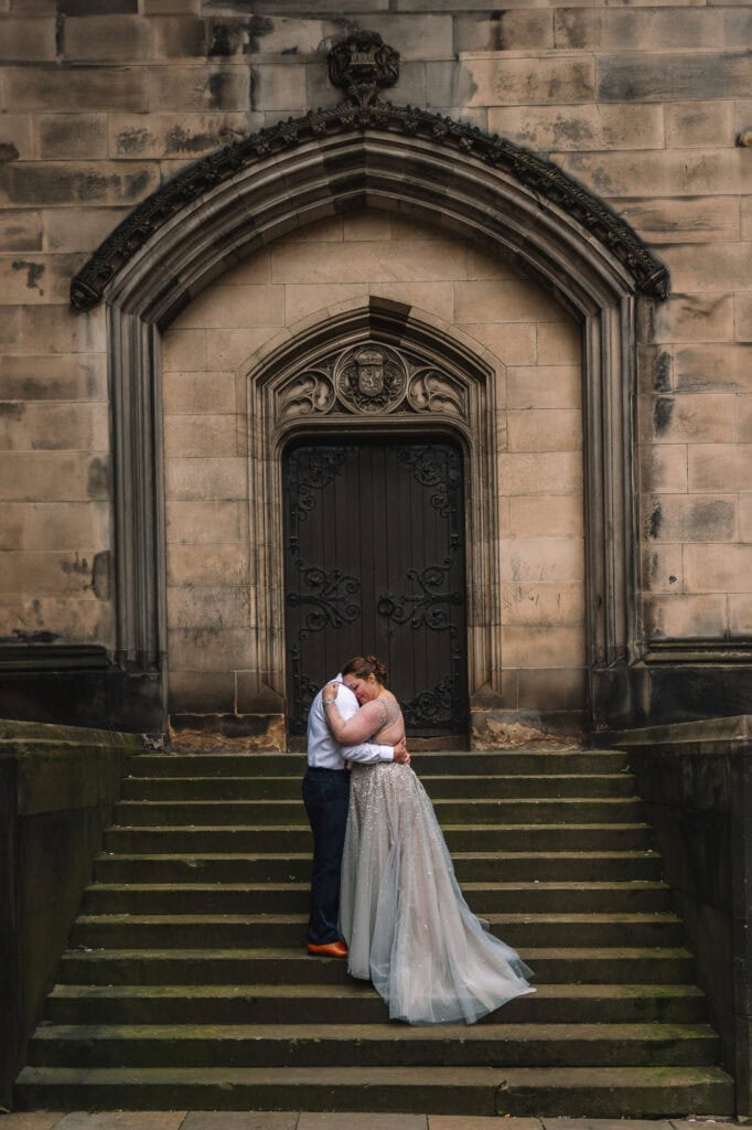 Couple standing together on cathedral steps