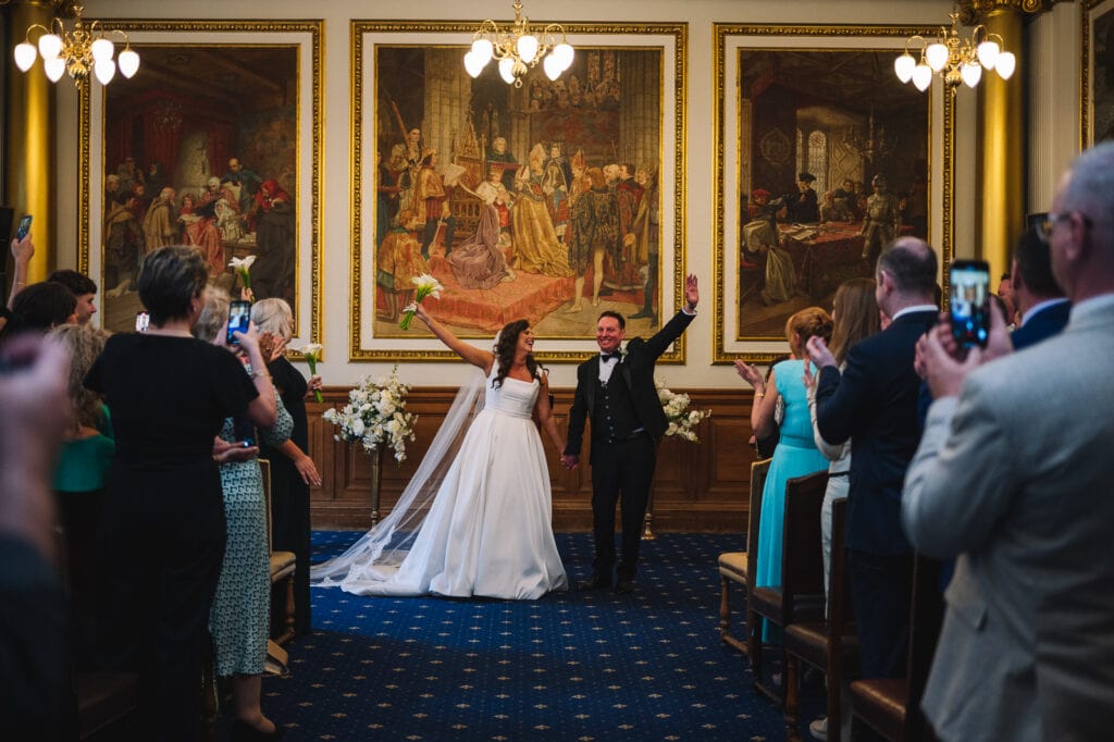 Bride and groom celebrating inside ceremony room
