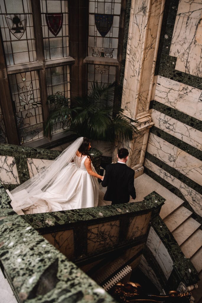 couple walking down historic stairs