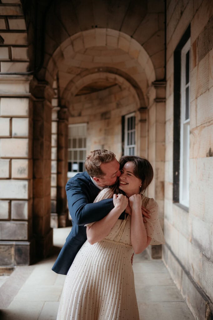 Couple walking through a quiet historic street in Edinburgh