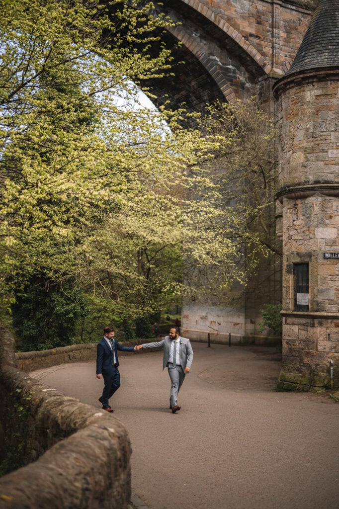Couple walking together through a quiet stone courtyard