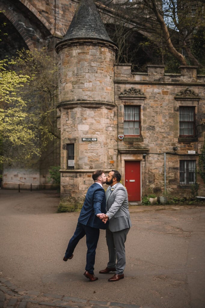  Couple standing together in a cobbled courtyard in Edinburgh