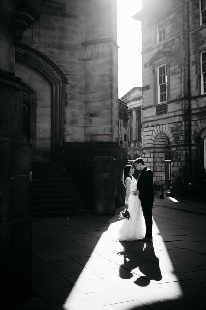 Black and white image of couple embracing in a city street
