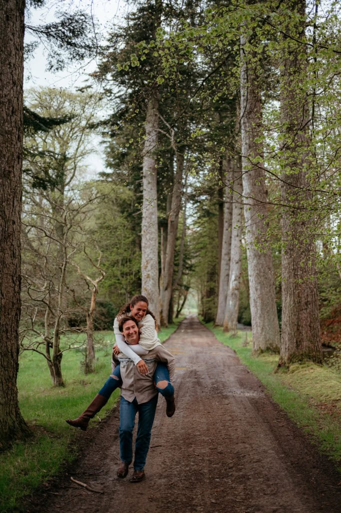  Couple embracing playfully on a woodland path