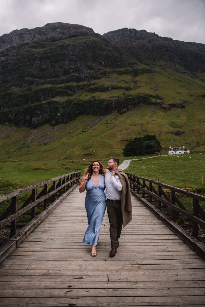 Couple walking along bridge in scenic countryside