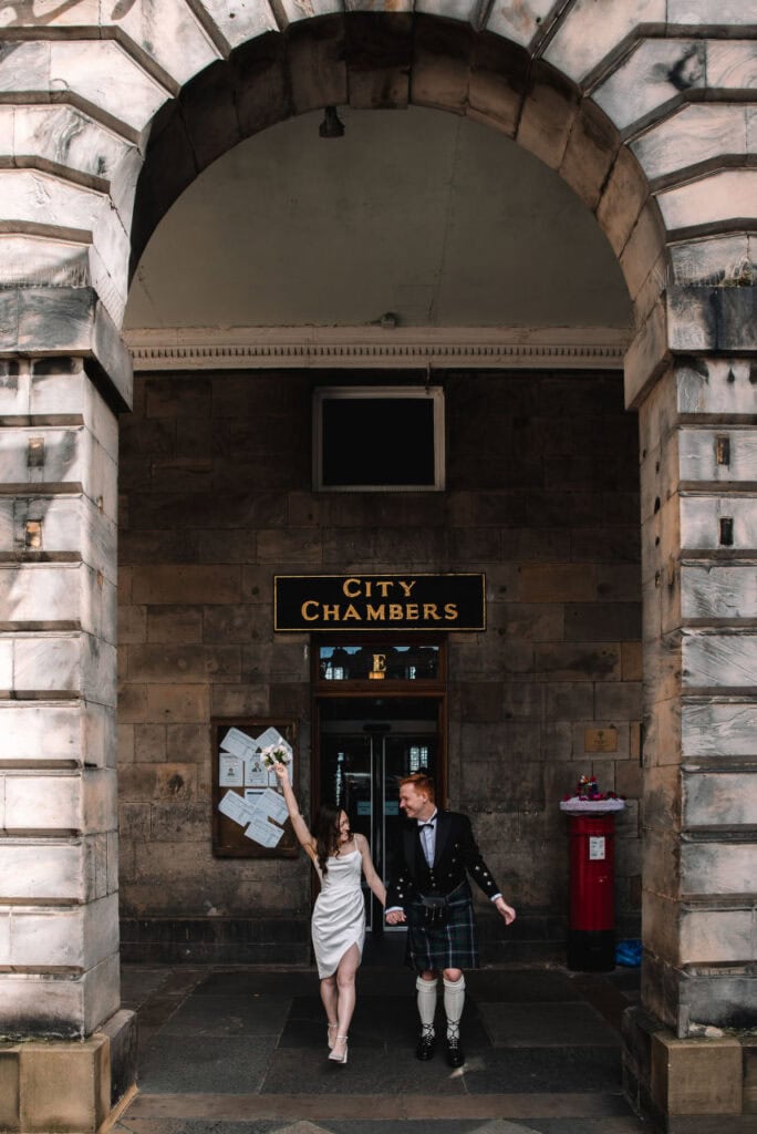 Bride and groom entering Edinburgh City Chambers for their wedding ceremony