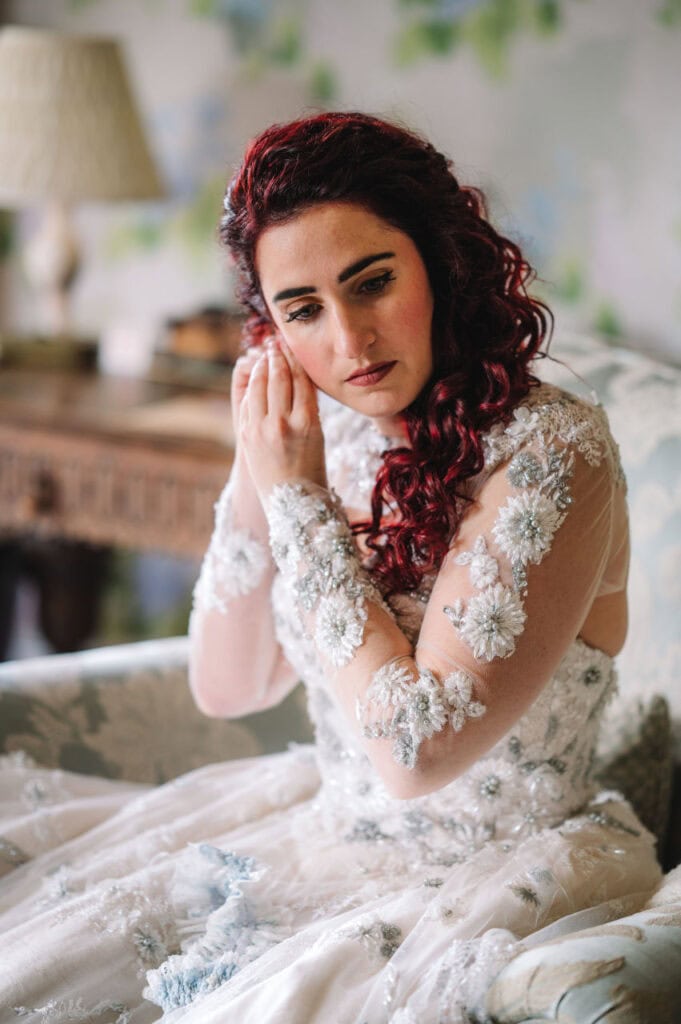 Bride adjusting earring in bridal preparation