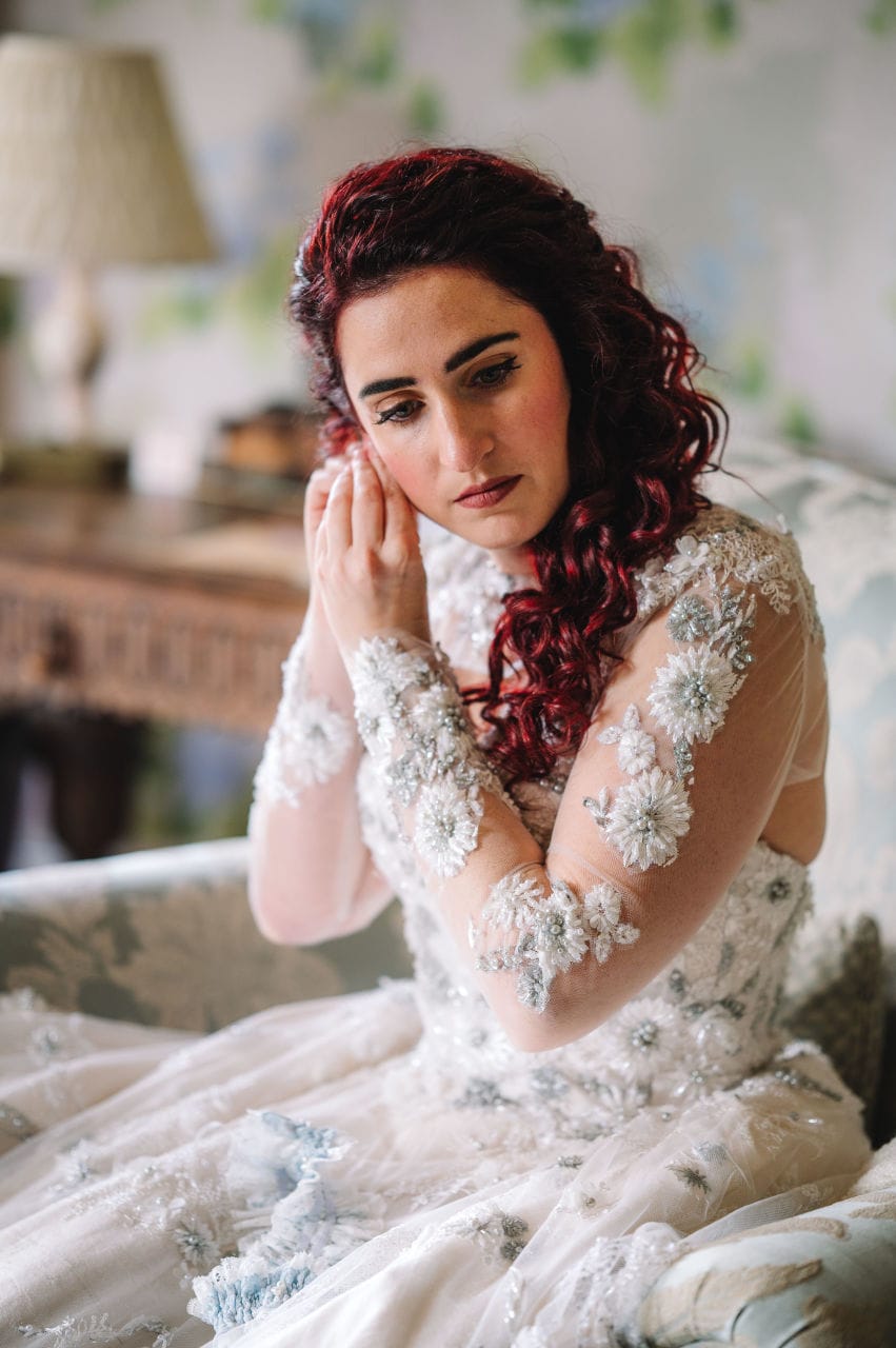 Bride adjusting earring in bridal preparation