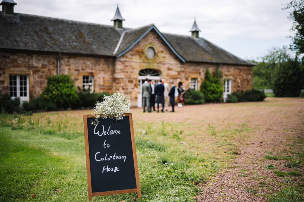 Guests gathering outside rustic stone wedding venue