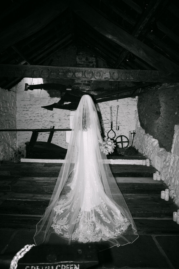 bride stands on steps of old smithy