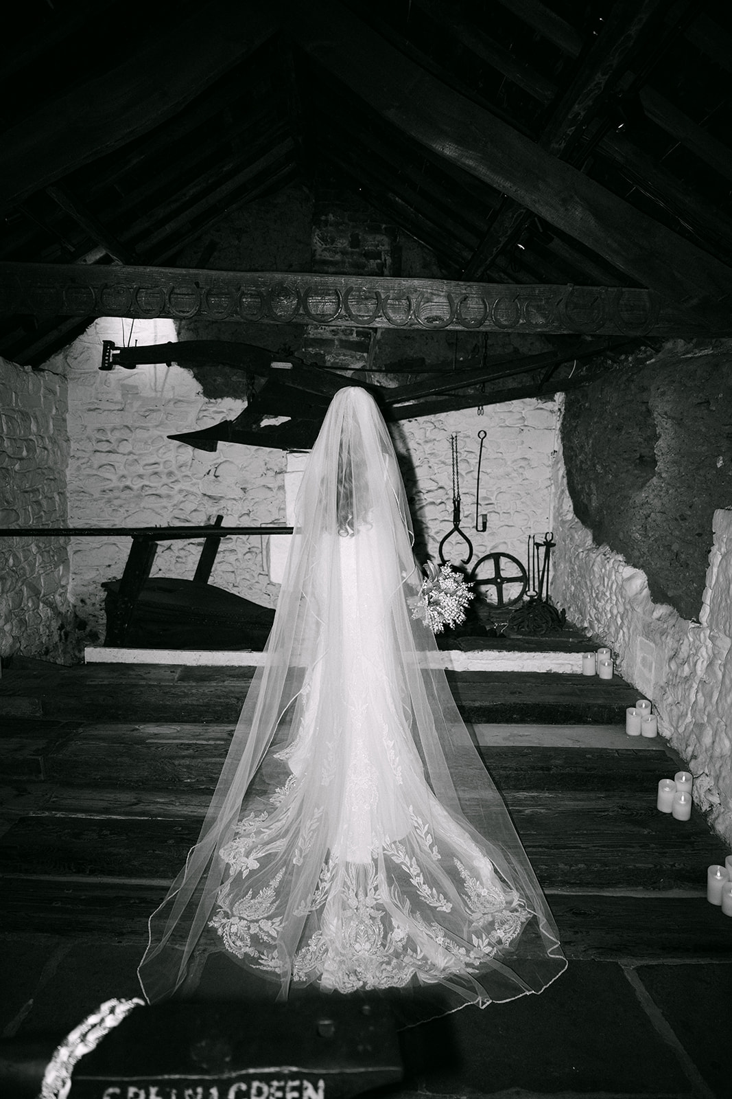 bride stands on steps of old smithy