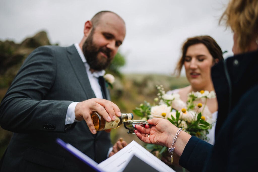 Close-up of hands during ring exchange ceremony