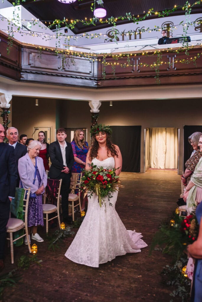 Bride walking down aisle indoors