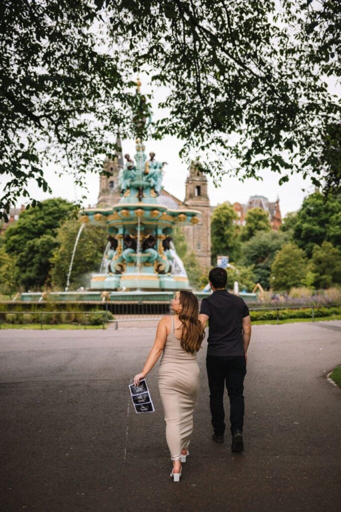 Couple posing in front of Ross Fountain with castle view