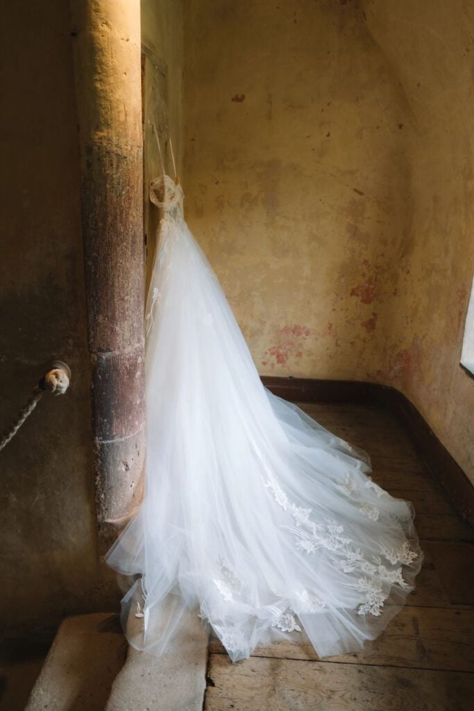 bride's dress hanging from a door