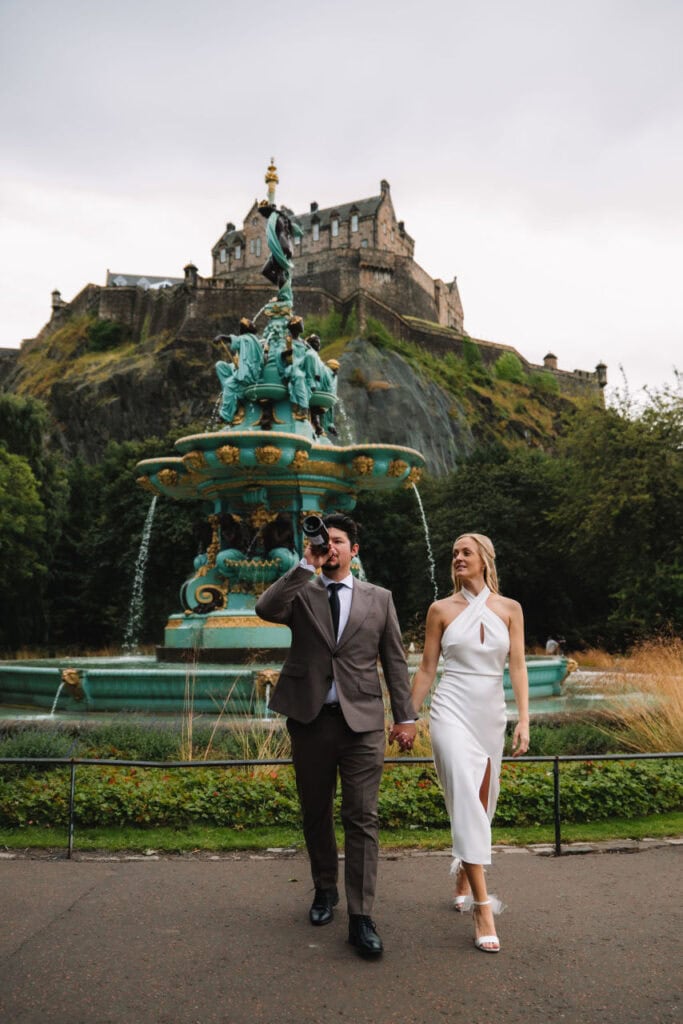 Couple walking near Ross Fountain with Edinburgh Castle behind