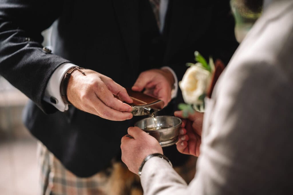 close-up of hands and quaich during ritual