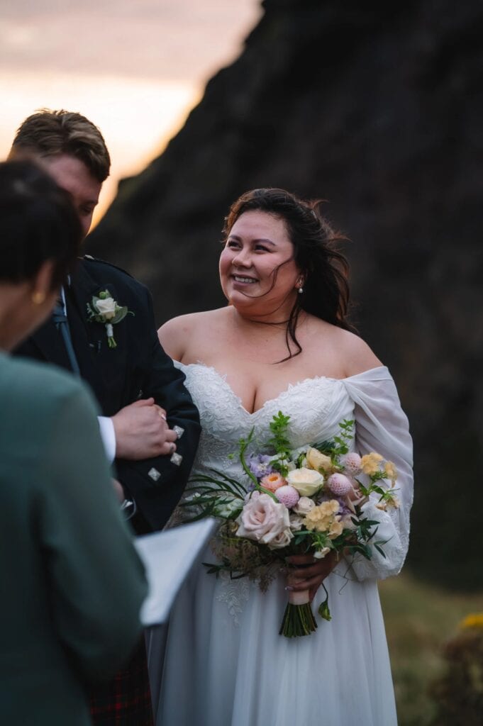 Bride smiling during outdoor ceremony in Scotland