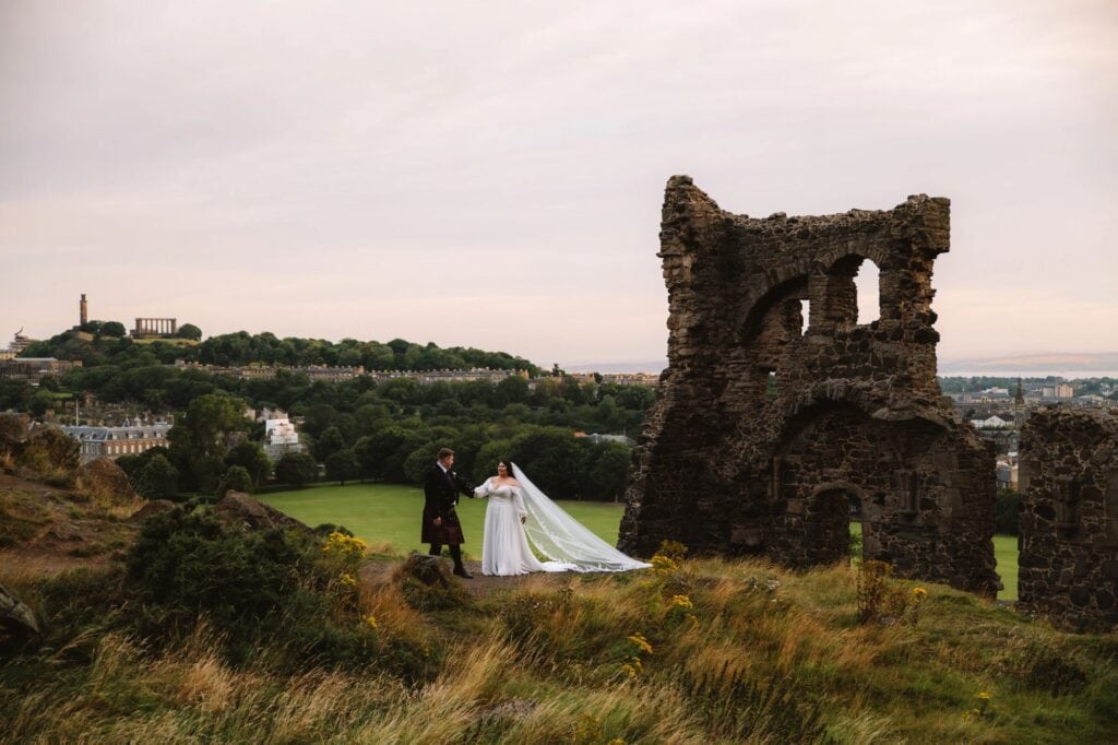 Couple standing near ruins with countryside view