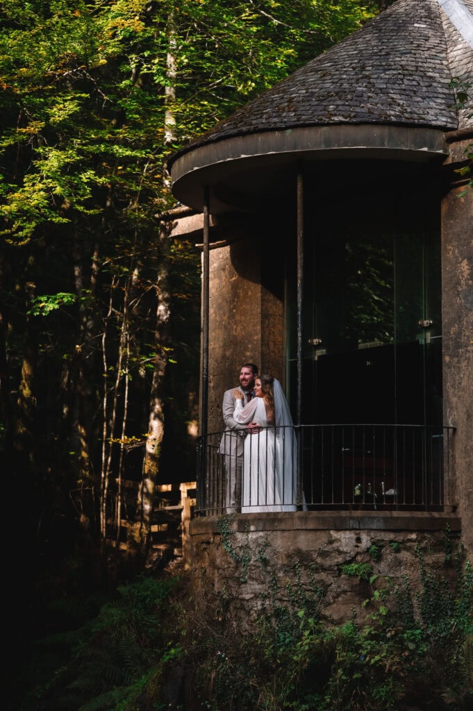 Couple standing together on forest balcony