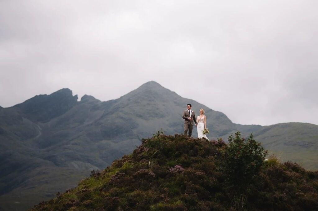 Couple standing on hilltop in Scottish Highlands
