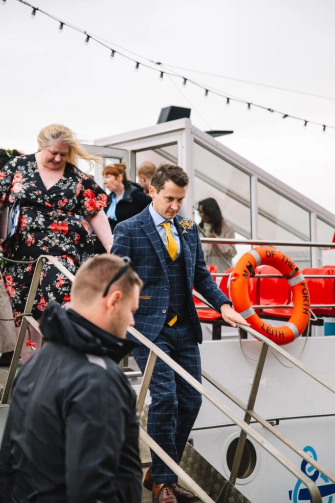 Guests boarding boat for wedding celebration