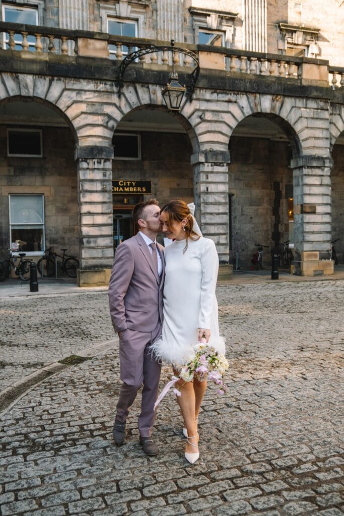 Couple standing outside historic Edinburgh building