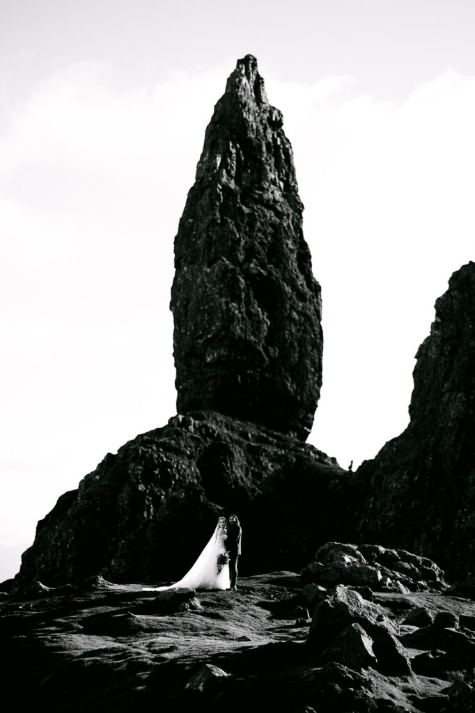 Tall rock spire formation in rugged Highland landscape.