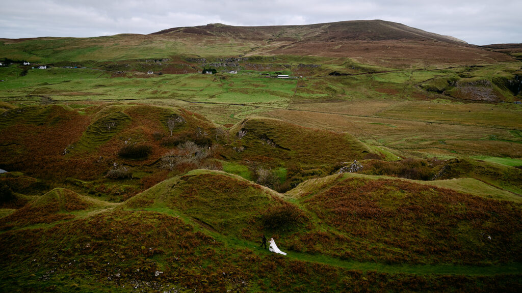 Rolling green hills and valley landscape in Scottish Highlands.