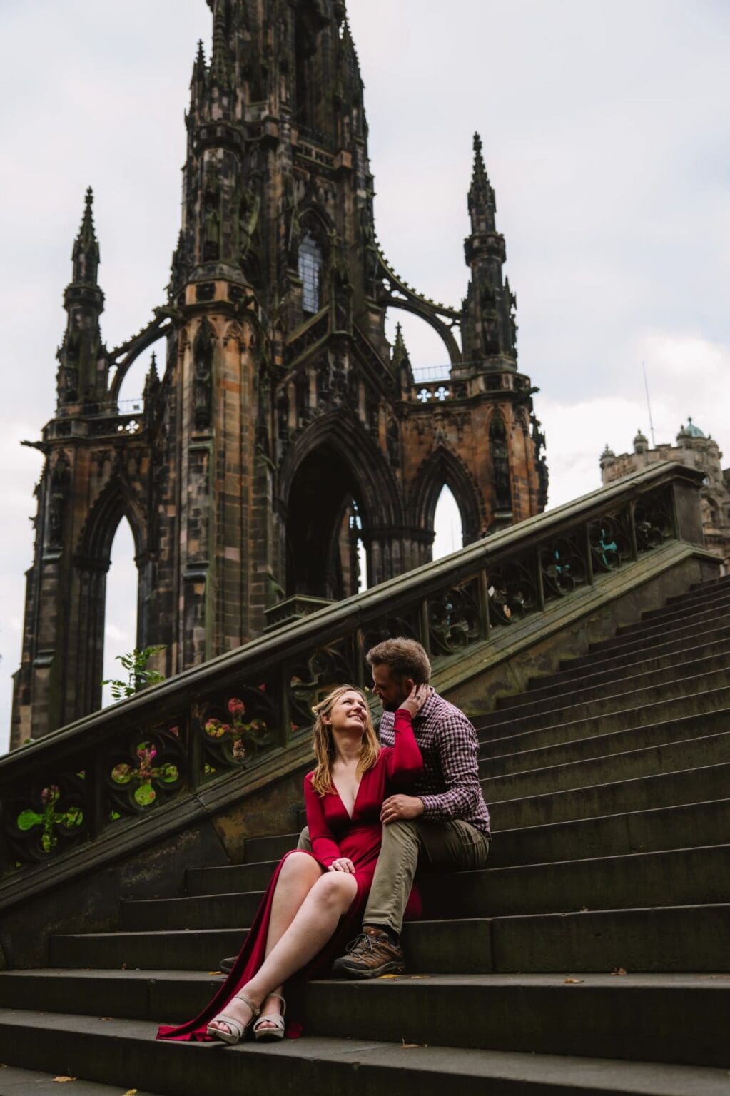 Couple sitting near Scott Monument in Edinburgh