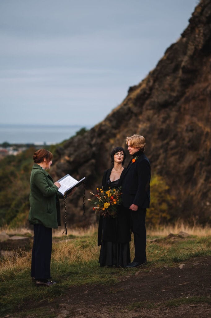 Outdoor wedding ceremony on hillside in Scotland