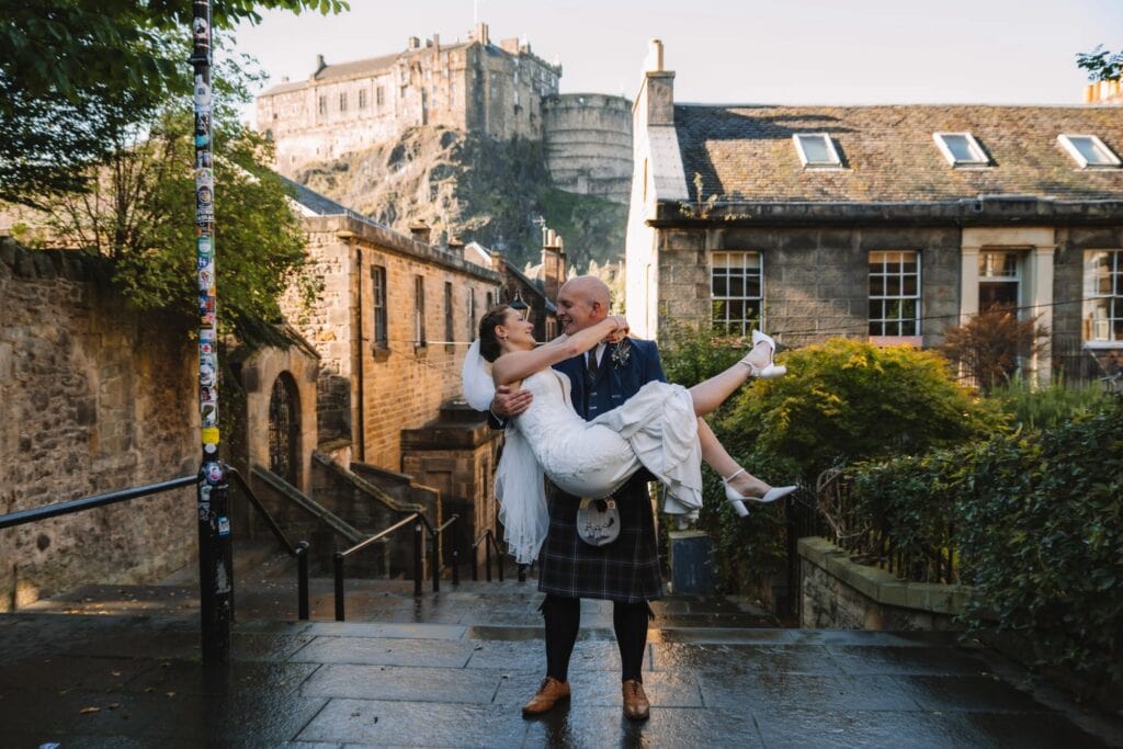Groom lifting bride on Edinburgh Old Town steps