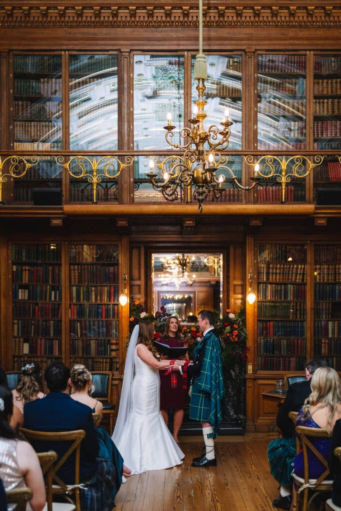 Bride and groom exchanging smiles during ceremony indoors