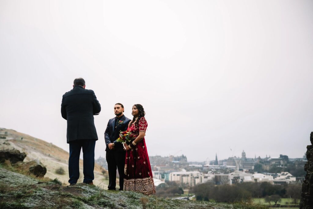 Couple standing together overlooking city skyline.