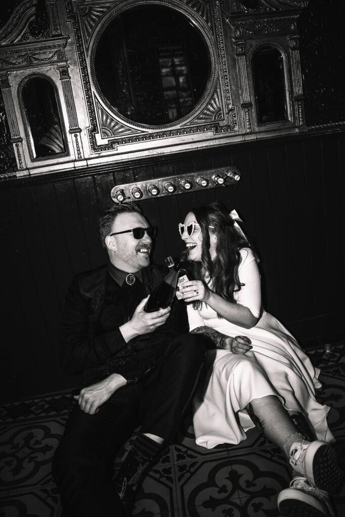 Black and white portrait of couple enjoying drinks together.