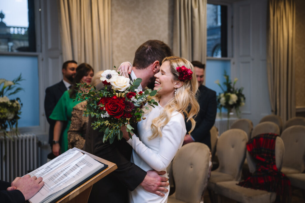 Couple kissing during small wedding ceremony
