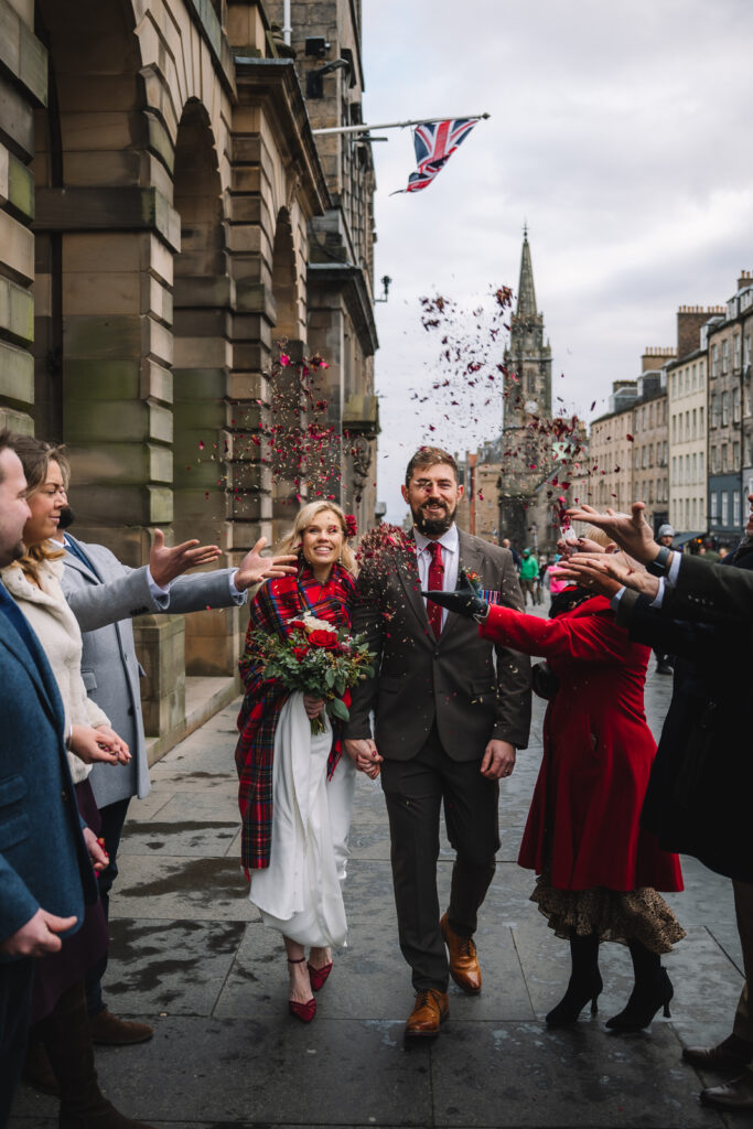 Wedding confetti moment outside historic Edinburgh building