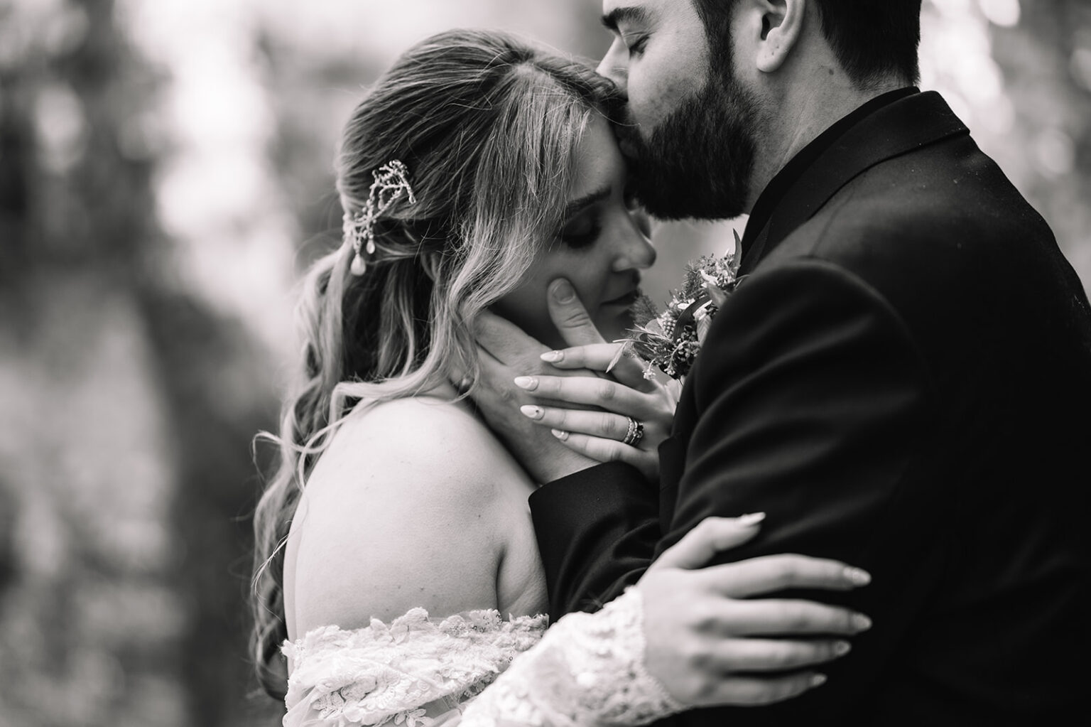 Black and white close-up of couple embracing intimately.