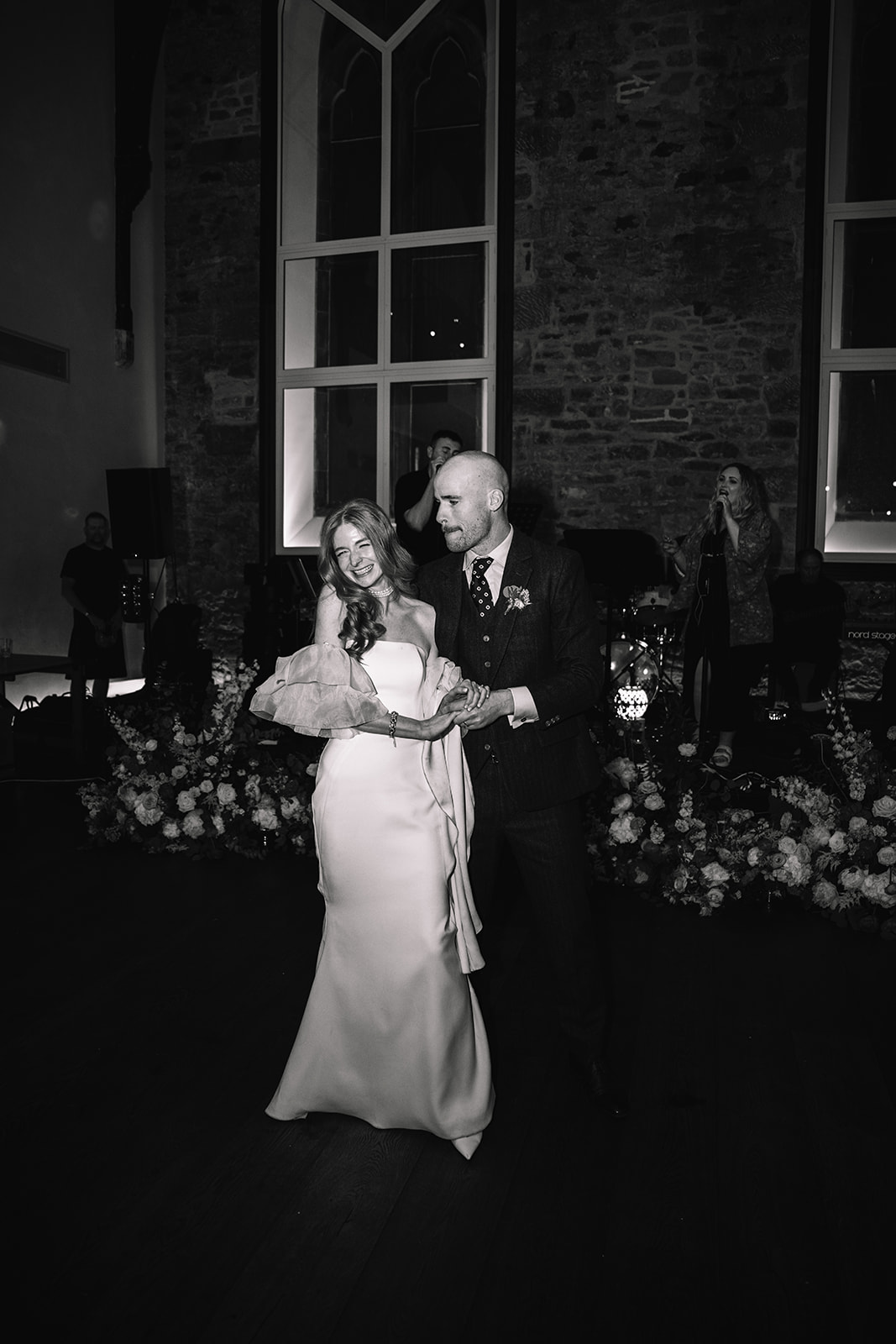Couple dancing together during evening reception.