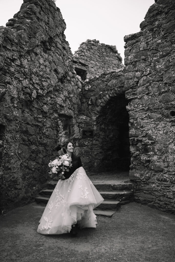 bride walks to ceremony at Dunnottar Castle