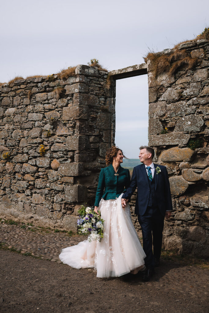 bride and groom stand in doorway at Dunnottar Castle