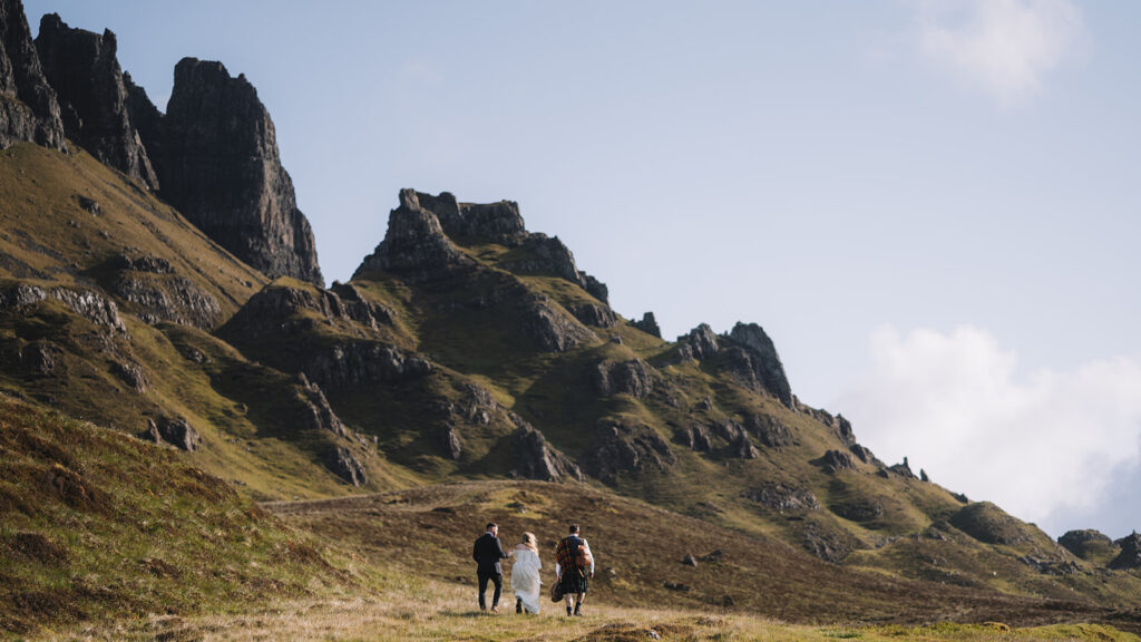 Couple walking through rugged mountain landscape together.