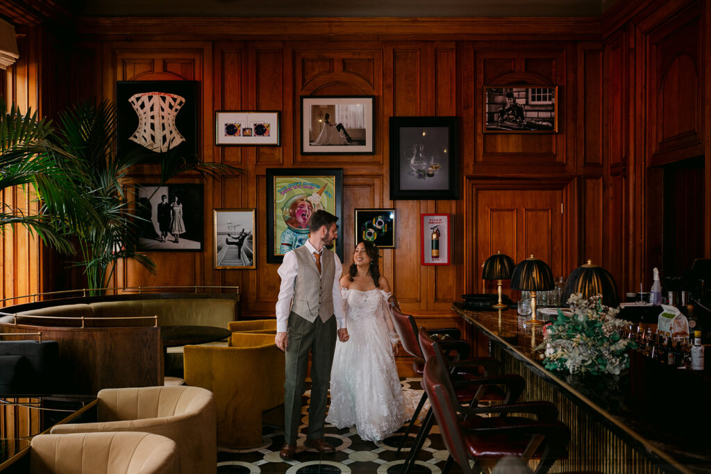 Bride and groom standing together in stylish interior room.