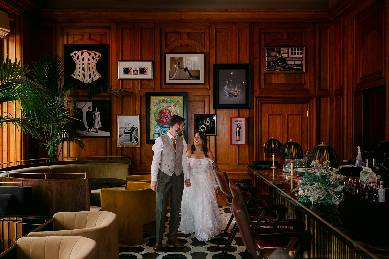 Bride and groom standing together in stylish interior room.