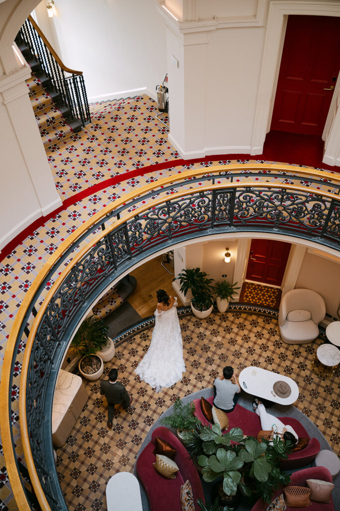Overhead view of circular staircase with couple below.