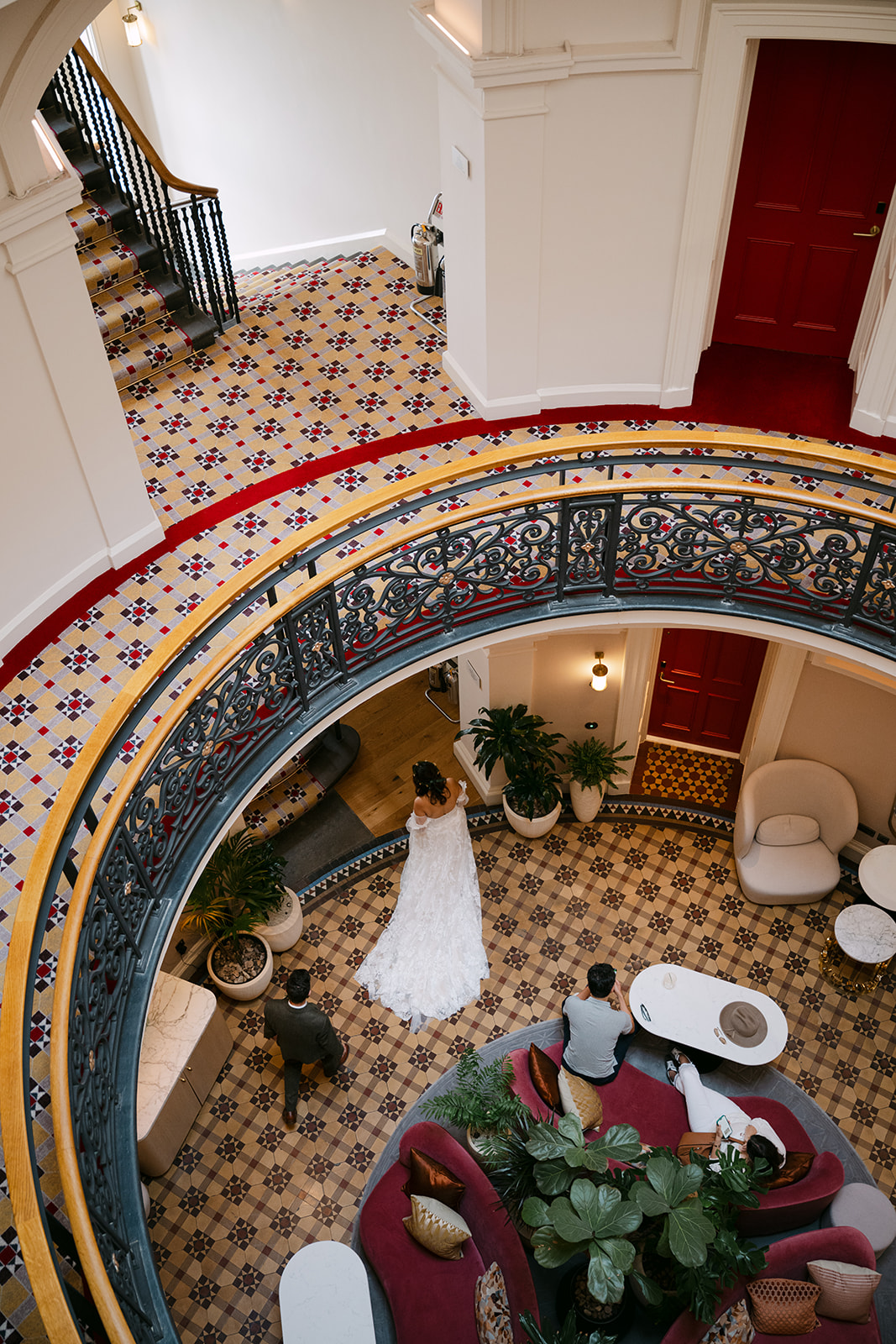 Overhead view of circular staircase with couple below.